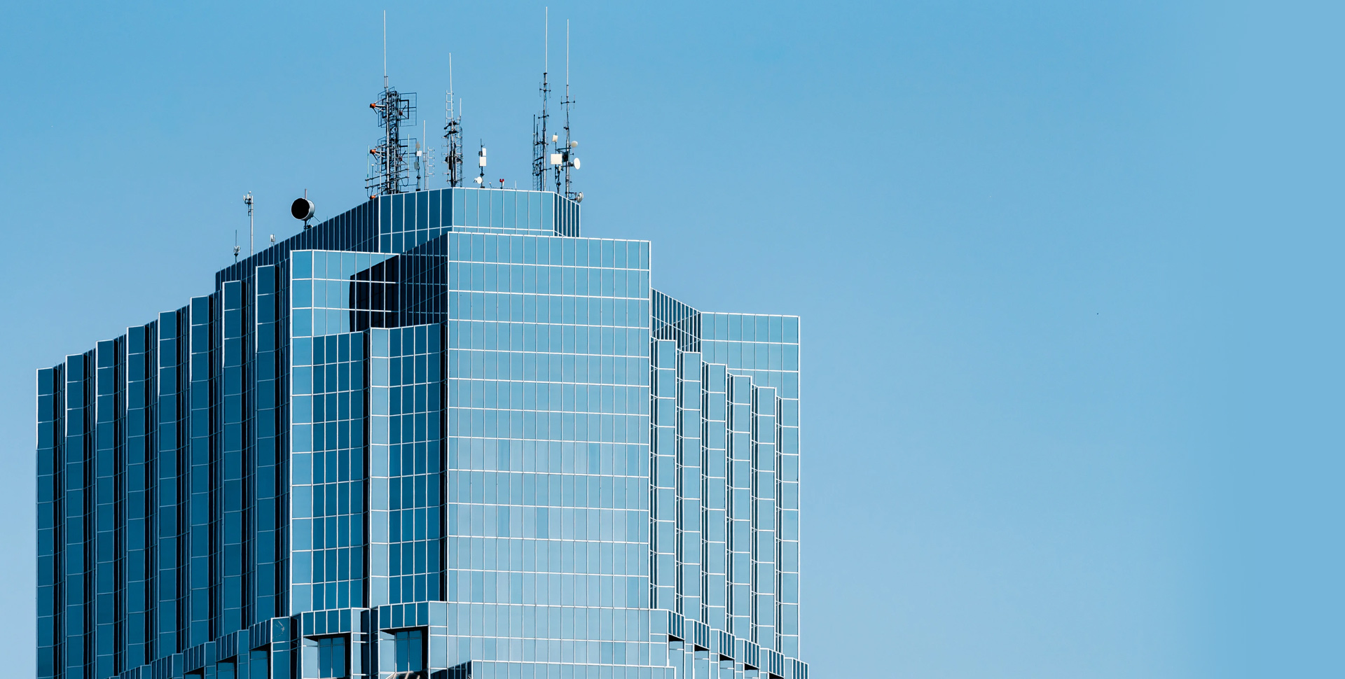 A modern building over a blue sky.