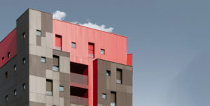 A modern building over a blue sky.