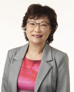 A portrait of a woman wearing business attire.