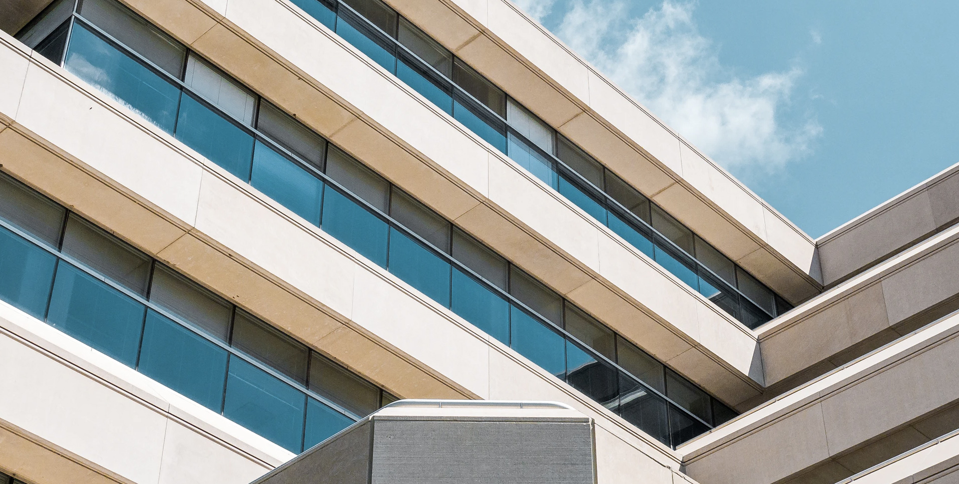 A modern building over a blue sky.