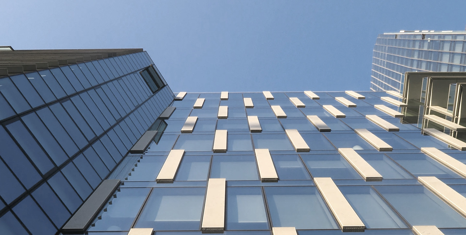 A modern building shot over a blue background.