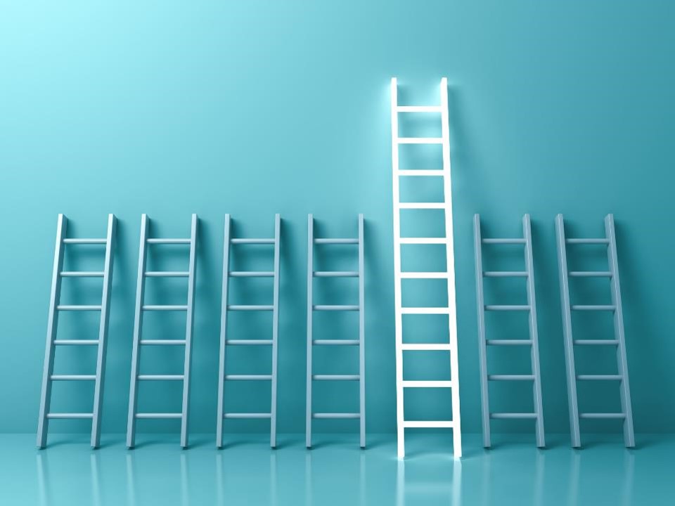 Concept shot of multiple ladders leaning against the blue wall. One of them is taller and highlighted in white.